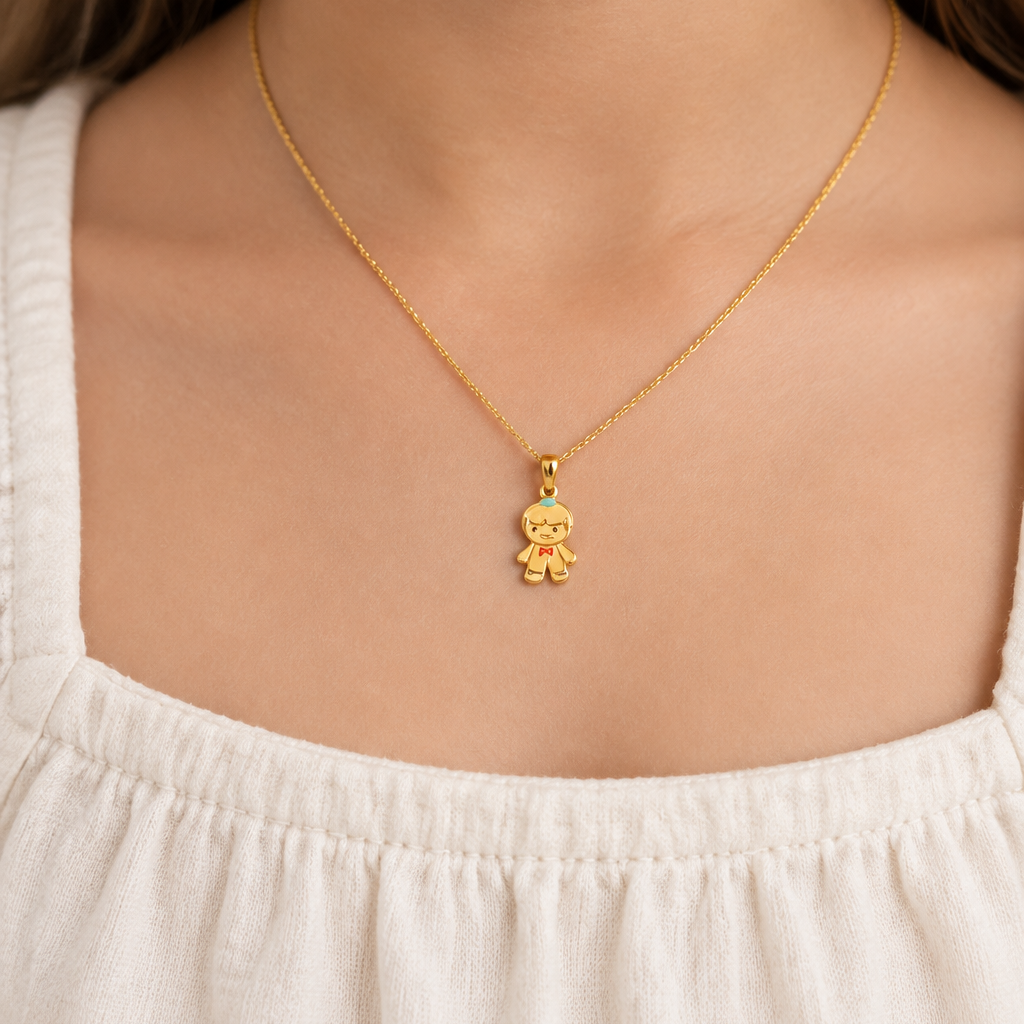 Gold boy-shaped charm pendant with enamel detailing, priced under Rs. 25,000