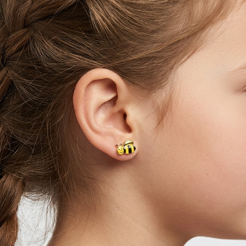 Gold stud earrings shaped like bees with yellow and black enamel stripes. Cute and minimal gold gifts for kids under Rs. 30,000