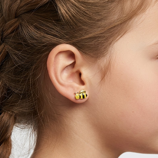 Gold stud earrings shaped like bees with yellow and black enamel stripes. Cute and minimal gold gifts for kids under Rs. 30,000