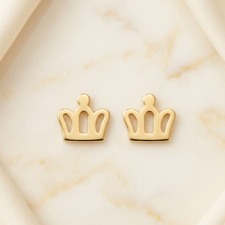 Polished gold crown-shaped stud earrings with an open cutout design. Perfect for gifting to kids under Rs. 20,000