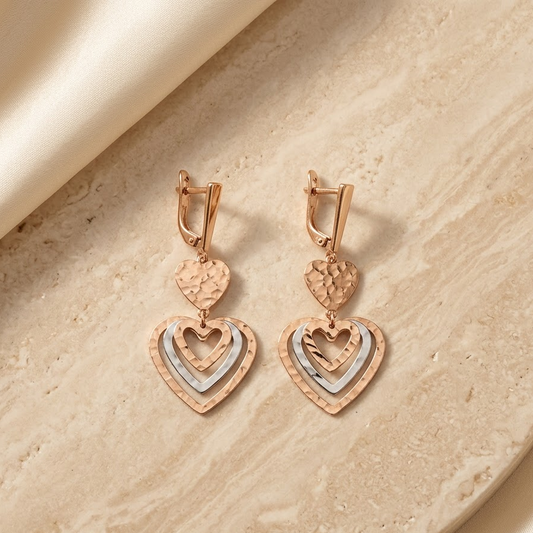 Rose-gold layered heart drop earrings with a textured top heart and pavé heart below. Luxe gold gifts for her under Rs. 80,000