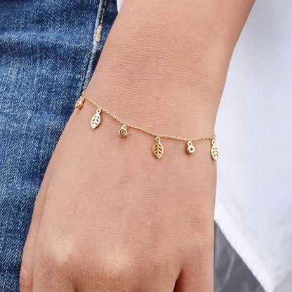 Caratly 18kt gold Leaf Diamond Bracelet featuring a delicate chain with alternating dangling open gold leaf charms and round diamond accents under Rs. 40,000