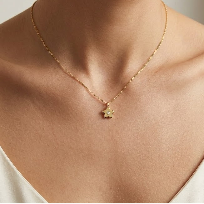 Gold star-shaped flower pendant set with a single sparkling diamond, priced under Rs. 25,000