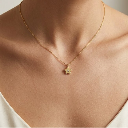 Gold star-shaped flower pendant set with a single sparkling diamond, priced under Rs. 25,000