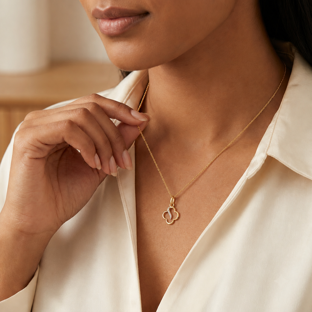 Gold clover-shaped pendant with a diamond-set swirl detail priced under Rs. 20,000