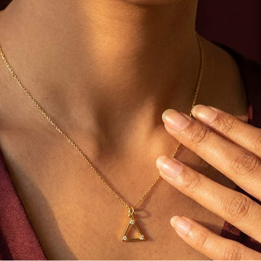 Gold triangle pendant outlined with sparkling diamond accents under Rs. 15,000