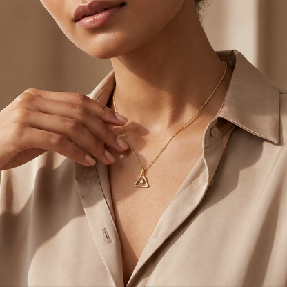 Gold double triangle pendant on a chain, set with a sparkling centre diamond priced under Rs. 15,000
