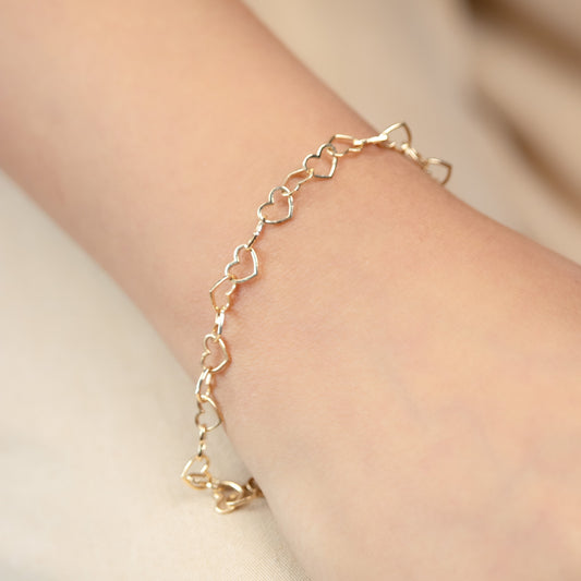 Caratly 18kt gold Interlinked Heart Bracelet with continuous open heart link design for women under Rs. 50,000