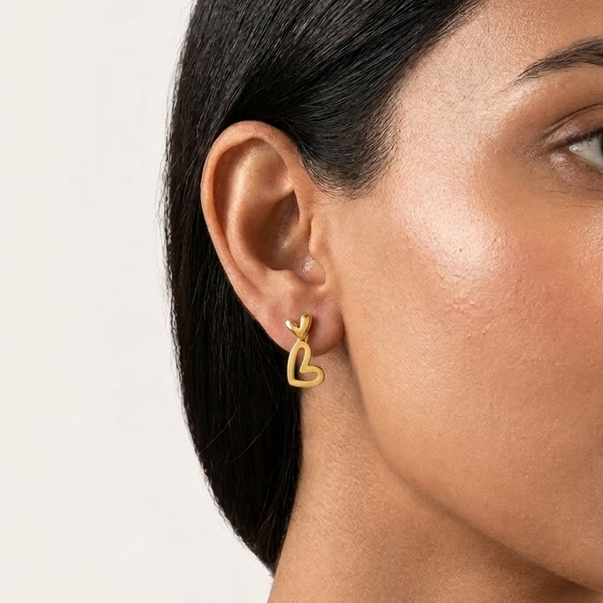 Gold open-heart dangle earrings with a small heart top and elongated heart drop. Perfect gift for her under at Rs. 30,000