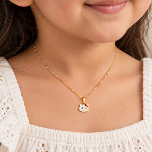 Gold kitty face pendant with a white enamel head and red bow accents under Rs. 20,000