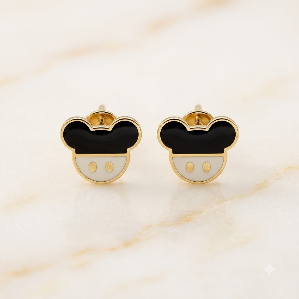 Gold stud earrings shaped like a mouse face with black and white enamel. Cute disney gifts for kids under Rs. 25,000