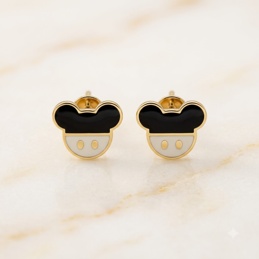 Gold stud earrings shaped like a mouse face with black and white enamel. Cute disney gifts for kids under Rs. 25,000