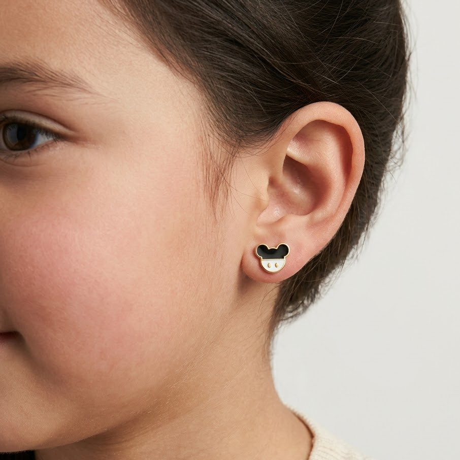 Gold stud earrings shaped like a mouse face with black and white enamel. Cute disney gifts for kids under Rs. 25,000