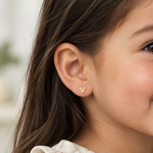 Polished gold stud earrings in the silhouette of a mouse-ear character face. Cute gold gifts for kids under Rs. 15,000