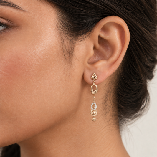 Gold dangle earrings with an oval link and layered beaded drops below. A luxe gift for her under Rs. 70,000