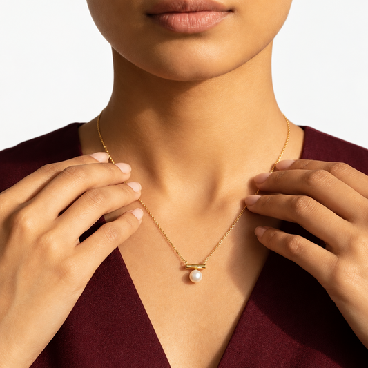 Gold bar-style pendant holding a large lustrous white pearl priced under Rs. 20,000
