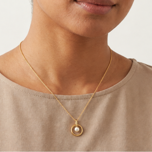 Gold circle pendant with a lustrous white pearl set at its centre. Minimal and cute gifts under Rs. 15,000