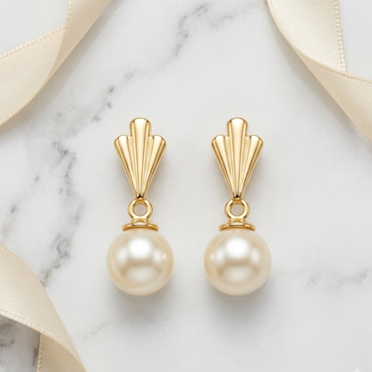 Gold drop earrings with a fluted cap and cream pearl. A perfect gift for her under Rs. 40,000