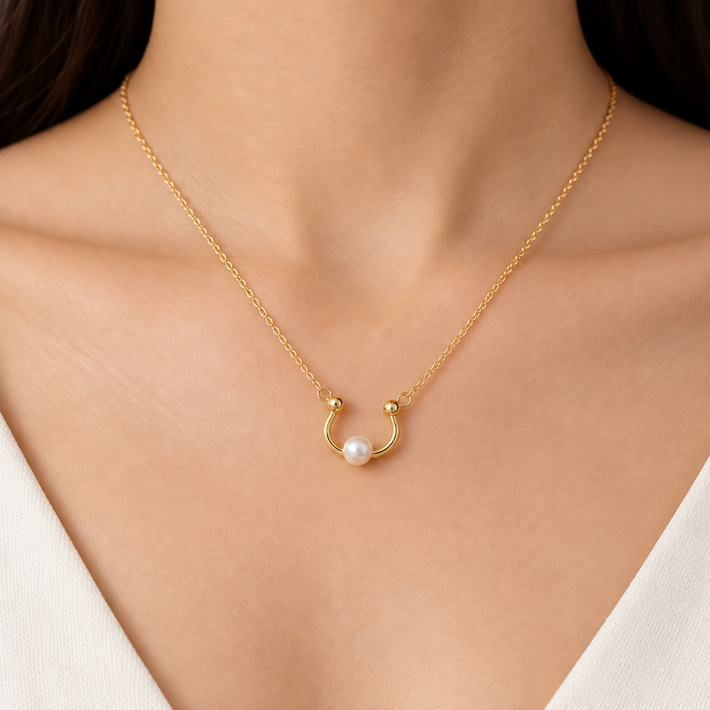 Gold curved open pendant with a smooth wrap design and a lustrous white pearl at one end priced under Rs. 23,000