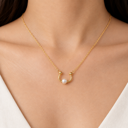 Gold curved open pendant with a smooth wrap design and a lustrous white pearl at one end priced under Rs. 23,000