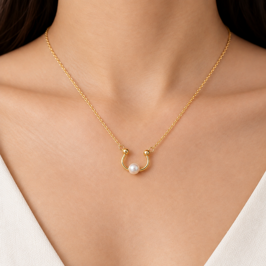 Gold curved open pendant with a smooth wrap design and a lustrous white pearl at one end priced under Rs. 23,000