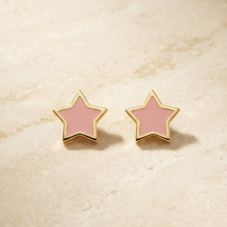 Gold star-shaped stud earrings with bright pink enamel and a gold outline. Minimal gifts for kids under Rs. 20,000
