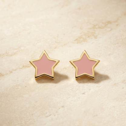 Gold star-shaped stud earrings with bright pink enamel and a gold outline. Minimal gifts for kids under Rs. 20,000