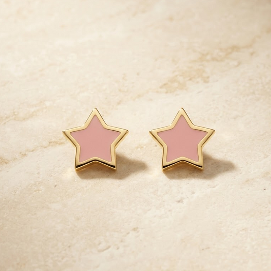Gold star-shaped stud earrings with bright pink enamel and a gold outline. Minimal gifts for kids under Rs. 20,000