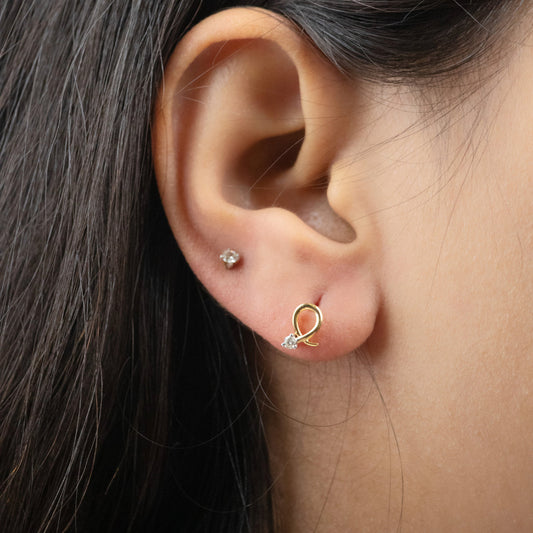 Caratly 18kt gold Loop Diamond Earring with 0.06ct diamond accent in a twisted gold wire loop design, minimal luxury gifts under Rs. 30,000