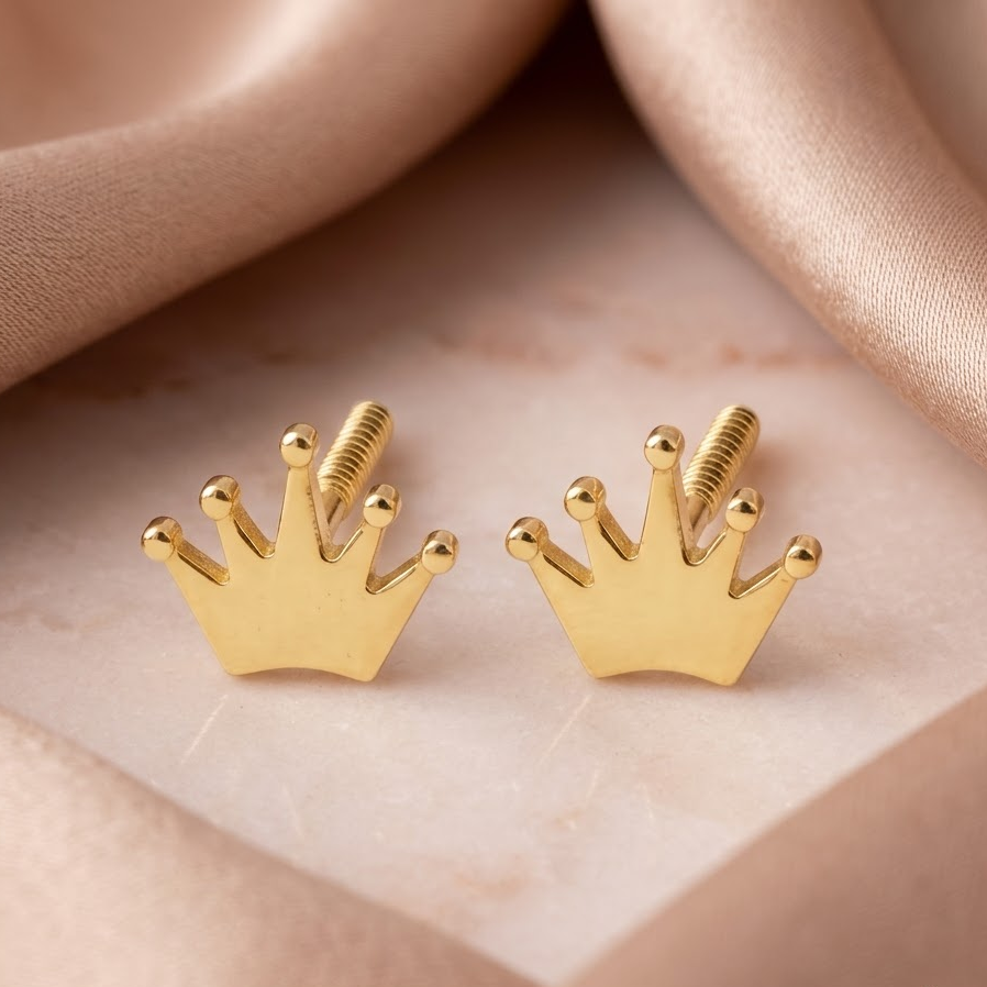 Gold crown-shaped stud earrings with a ridged, fan-textured surface. A perfect minimal gift for kids under Rs. 20,000 