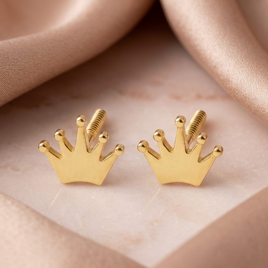 Gold crown-shaped stud earrings with a ridged, fan-textured surface. A perfect minimal gift for kids under Rs. 20,000 