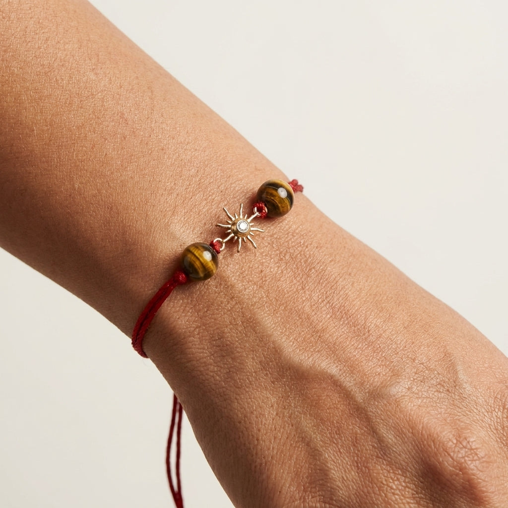 Gold sun diamond Rakhi with Tiger's eye beads.