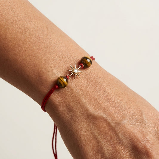 Gold sun diamond Rakhi with Tiger's eye beads.
