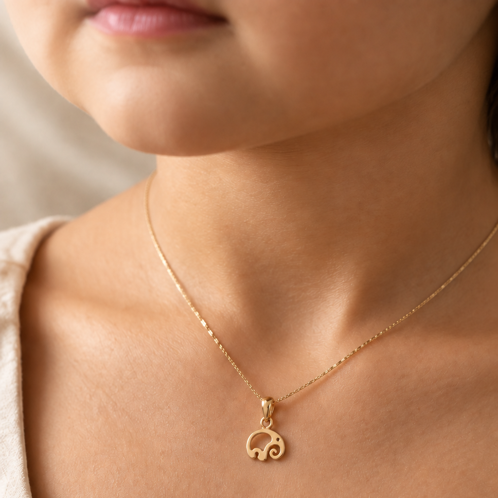 Gold pendant shaped like a swirled abstract elephant silhouette