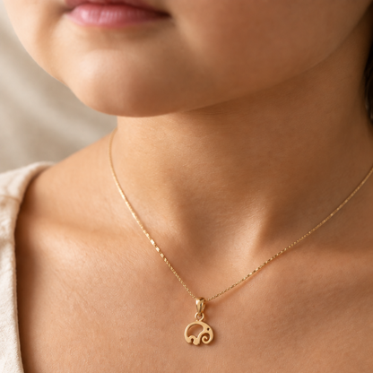 Gold pendant shaped like a swirled abstract elephant silhouette