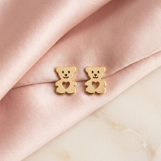 Gold teddy bear stud earrings with a heart-shaped cutout in the center under Rs. 20,000
