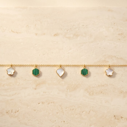 Gold chain bracelet with alternating green and white gemstone drops priced under Rs. 60,000