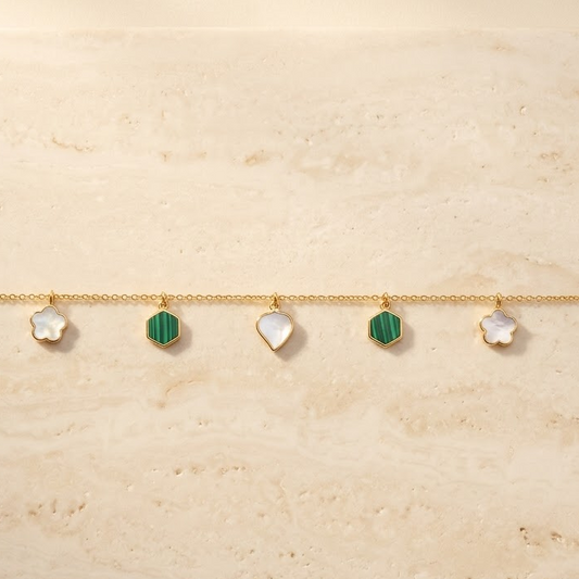 Gold chain bracelet with alternating green and white gemstone drops priced under Rs. 60,000