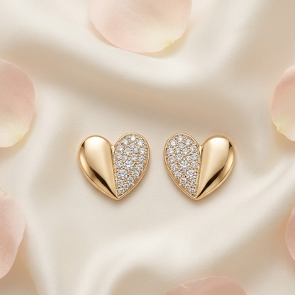 Gold heart-shaped stud earrings, one half polished and one half paved with diamonds. Minimal gifts for her under Rs. 35,000