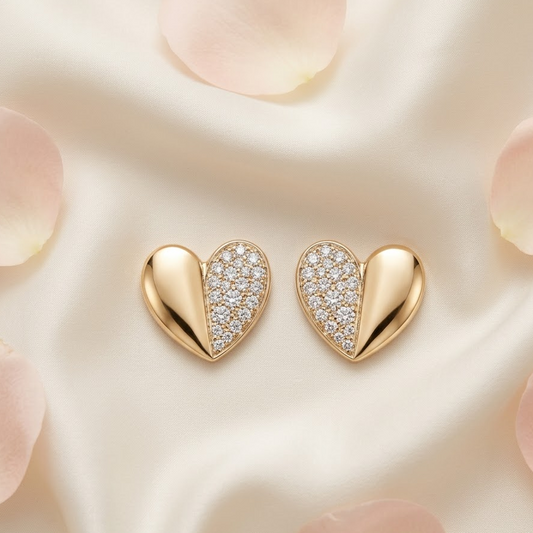 Gold heart-shaped stud earrings, one half polished and one half paved with diamonds. Minimal gifts for her under Rs. 35,000