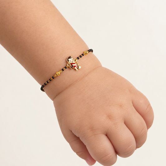 Black bead bracelet with a gold Hanuman charm at the center priced under Rs. 35,000