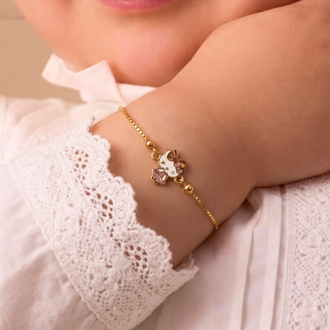 Gold link bracelet featuring a pink and white Hello Kitty charm. A minimal gold gift for kids under Rs. 40,000