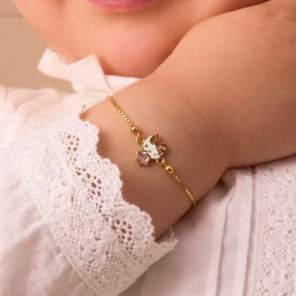 Gold link bracelet featuring a pink and white Hello Kitty charm. A minimal gold gift for kids under Rs. 40,000