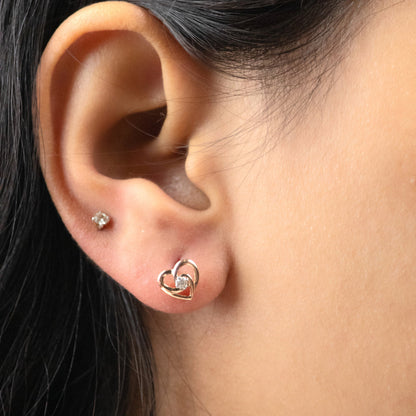 Caratly 18kt gold Heart Linked Earring with 0.07ct diamonds in an intertwined double heart stud design under Rs. 30,000