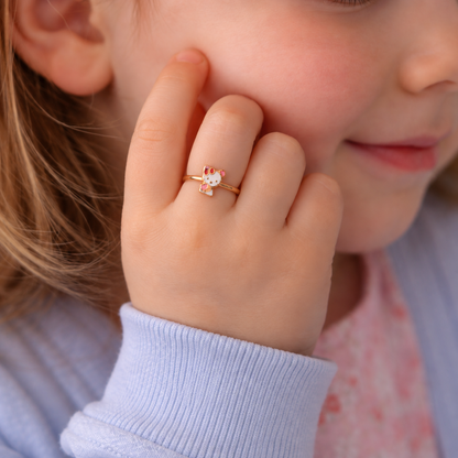 Rose gold ring with a white and pink enamel Hello Kitty charm and red bow. Cute and minimal gifts under Rs. 20,000
