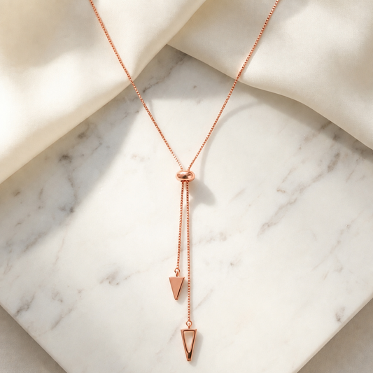 Rose gold lariat necklace with two dangling arrowhead-shaped drops. Luxe gifts for her under Rs. 85,000