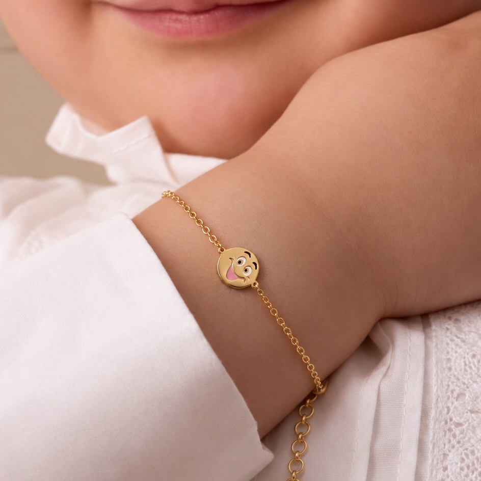 Gold bracelet with a brown laughing-face enamel charm at the center. Cute gifts for kids under Rs. 35,000
