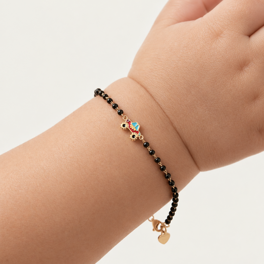 Black bead bracelet with a red and gold race car charm at the center priced under Ra. 30,000