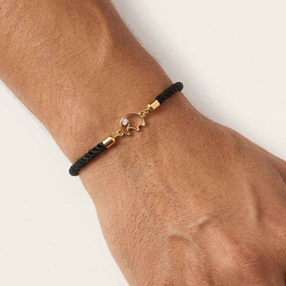 Black rope men's bracelet with an 18kt gold elephant charm and a diamond accent. A gold gift for him under Rs. 15,000
