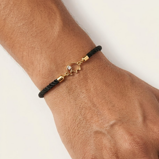 Black rope men's bracelet with an 18kt gold elephant charm and a diamond accent. A gold gift for him under Rs. 15,000